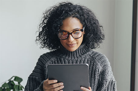 woman reading about health plans on tablet