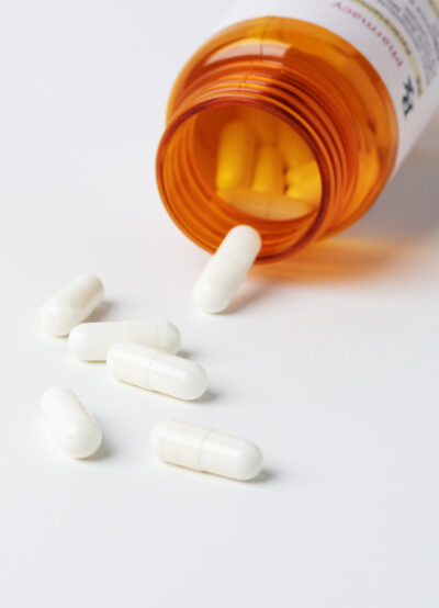 open prescription bottle with Pills for viral disease spilled
