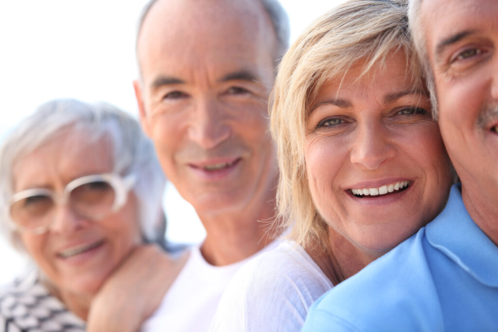 2 older couples smiling in a group -Clinical Pharmacy Services