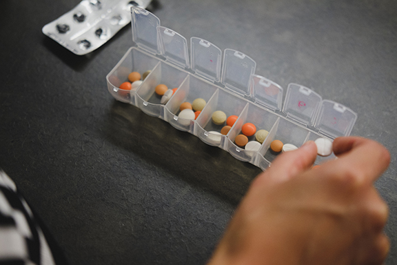 pill box organizer with colorful pills demonstrating chronic condition management